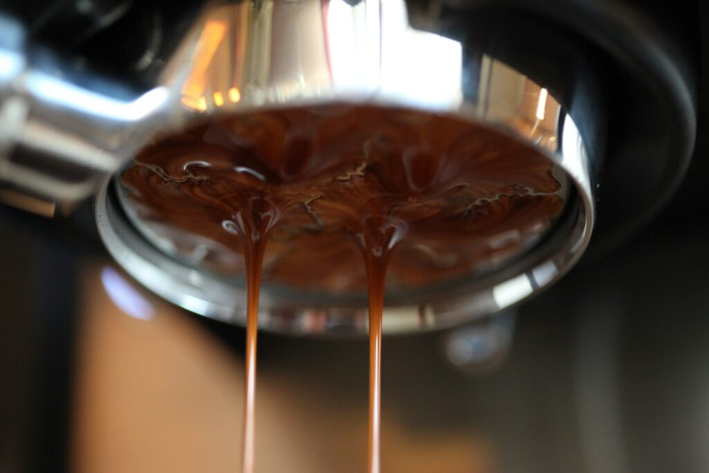 Espresso pouring from a portafilter on an espresso machine
