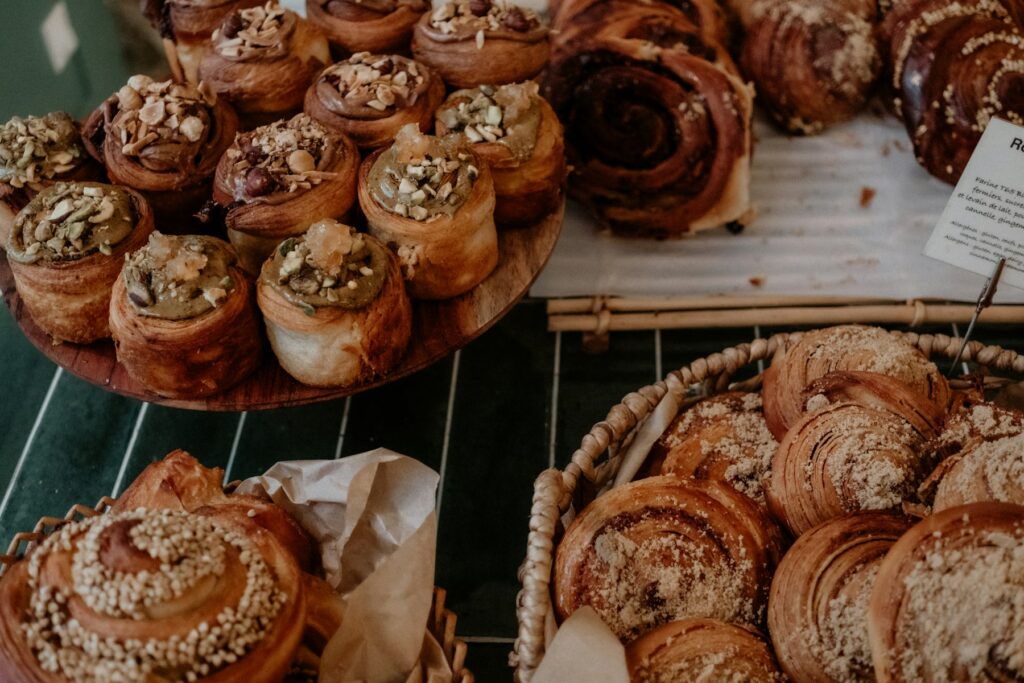 Catering Assorted cinnamon buns and pastries on a bakery rack